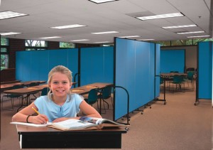Female student sitting and a desk doing school work in a Multi Purpose Room Female student sitting and a desk doing school work in a Multi Purpose Room