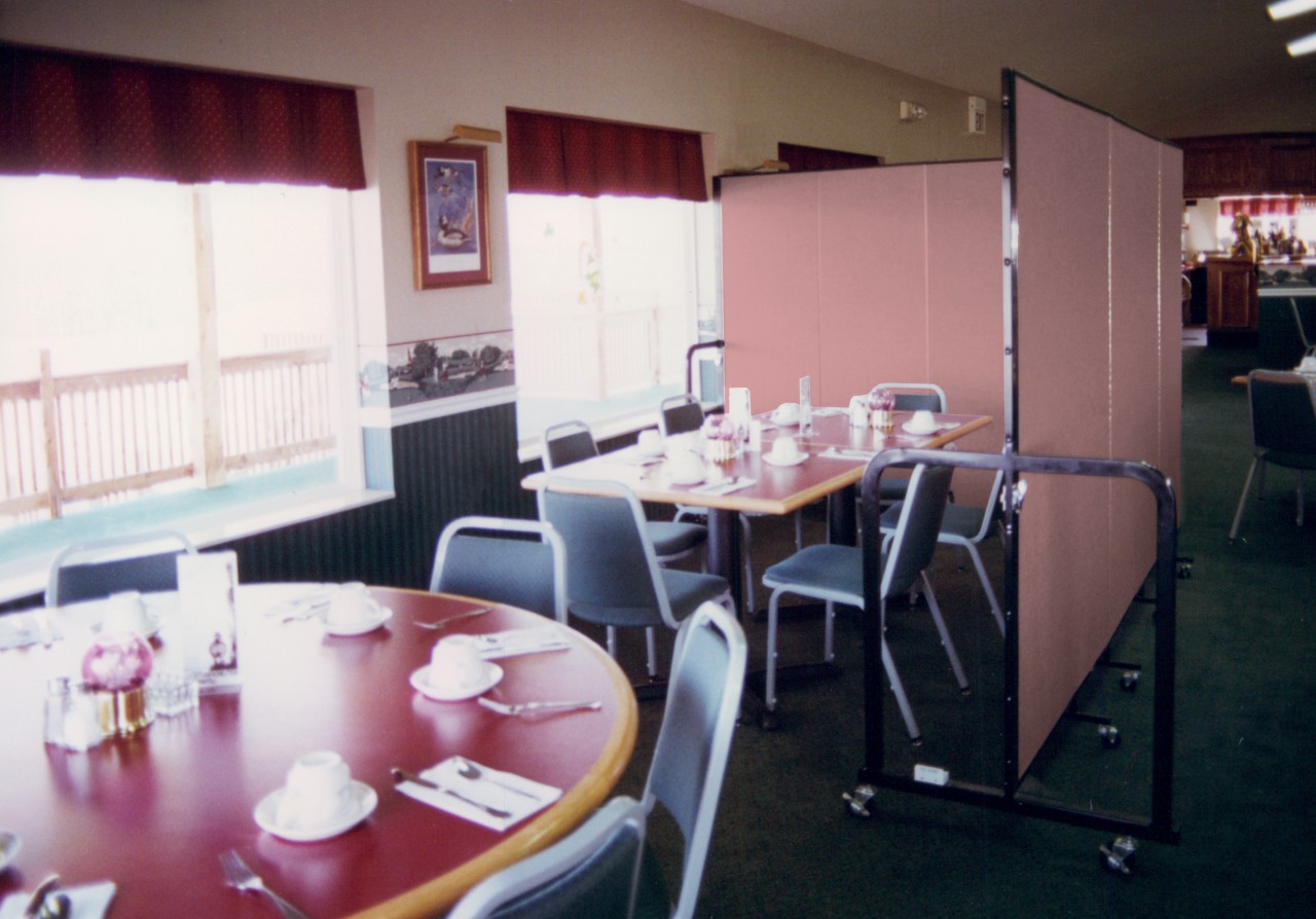 Divider is rolled into place to provide some privacy for a small group meeting in a restaurant in VFW Halls