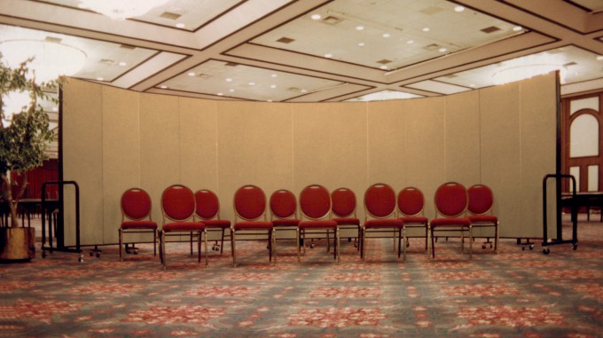 Portable wall is set up around this group of chairs to help limit distractions during the speaker's talk.