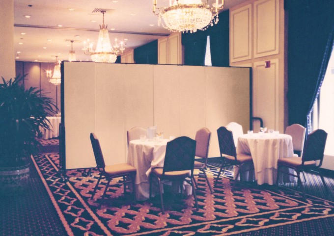 A portable folding wall is easily rolled into place to help provide added privacy for an intimate dining experience.