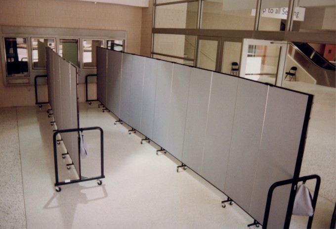 Two dividers create three separate lines for crowd control at a ticket window 