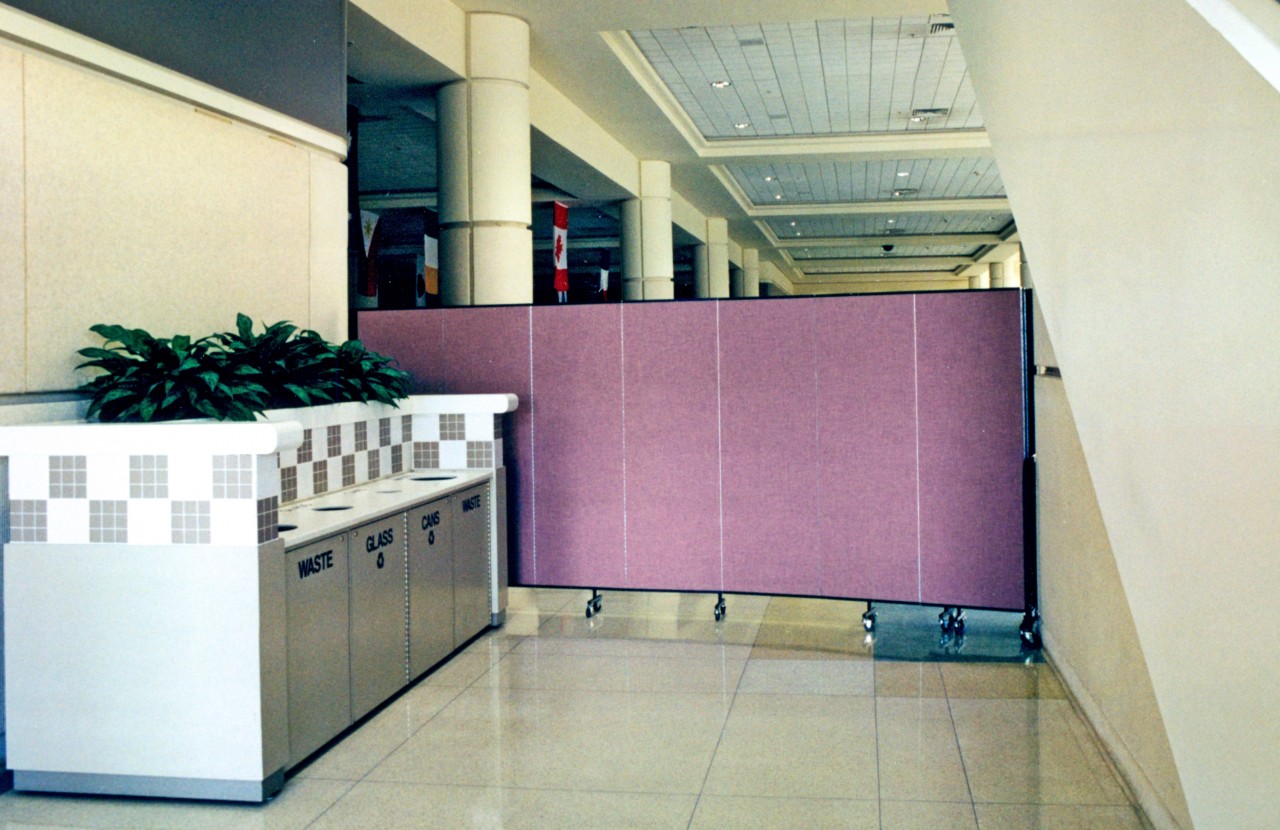 An area under construction in a convention center is blocked by a portable partition