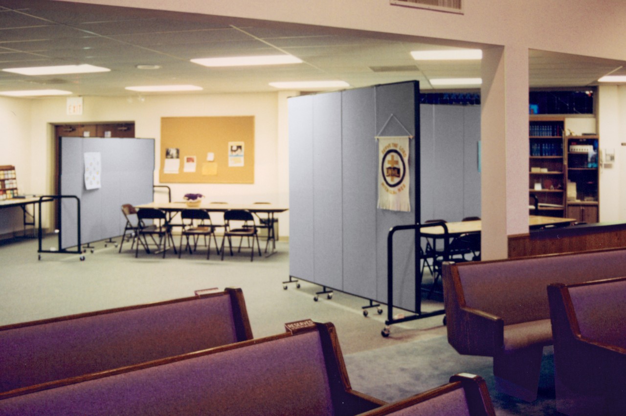 A room divider blocks an entrance to a church sanctuary in a basement room