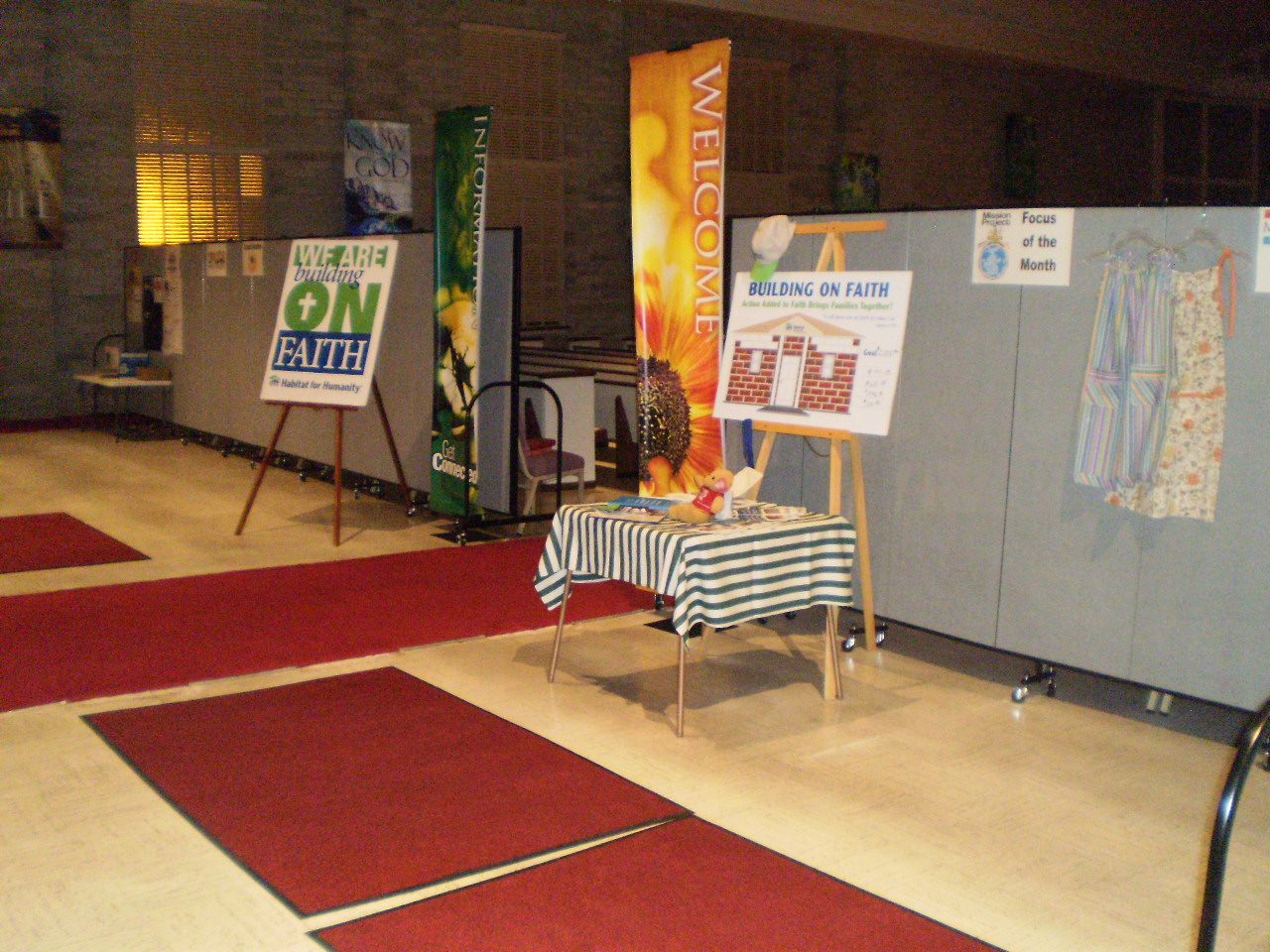 Church flyers and information are displayed on and around room dividers near the rear of a church