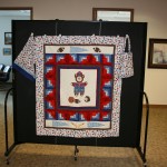 A boy sports themed handmade quilt