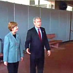 President and First Lady Bush speak to guests at an airport in front of a wall of Screenflex Room Dividers