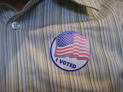 I voted sticker on a men's dress shirt