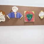children artwork tacked to acoustical wall panel