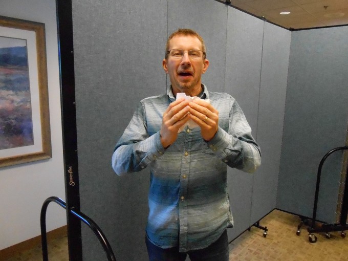 A man about to sneeze and cover his nose with a tissue