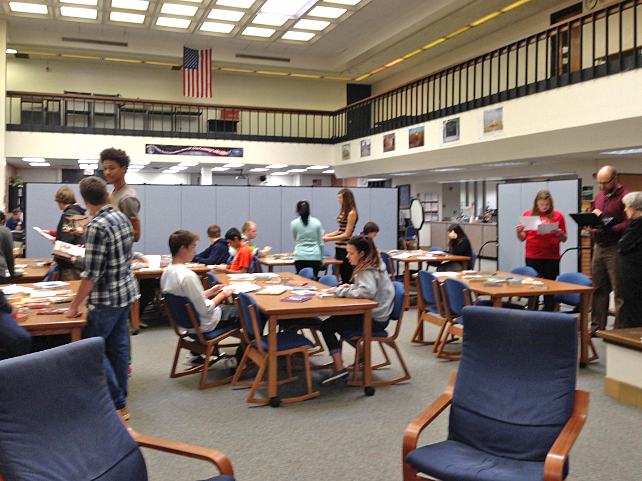 Students work on projects in a high school library classroom made with Screenflex Portable Room Dividers.