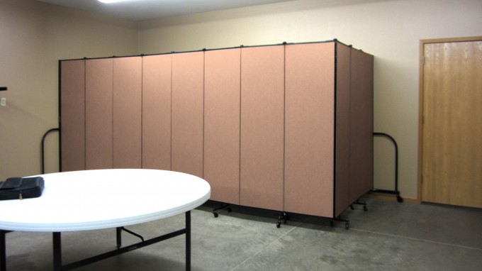 Folding partition walls hide tables and chairs