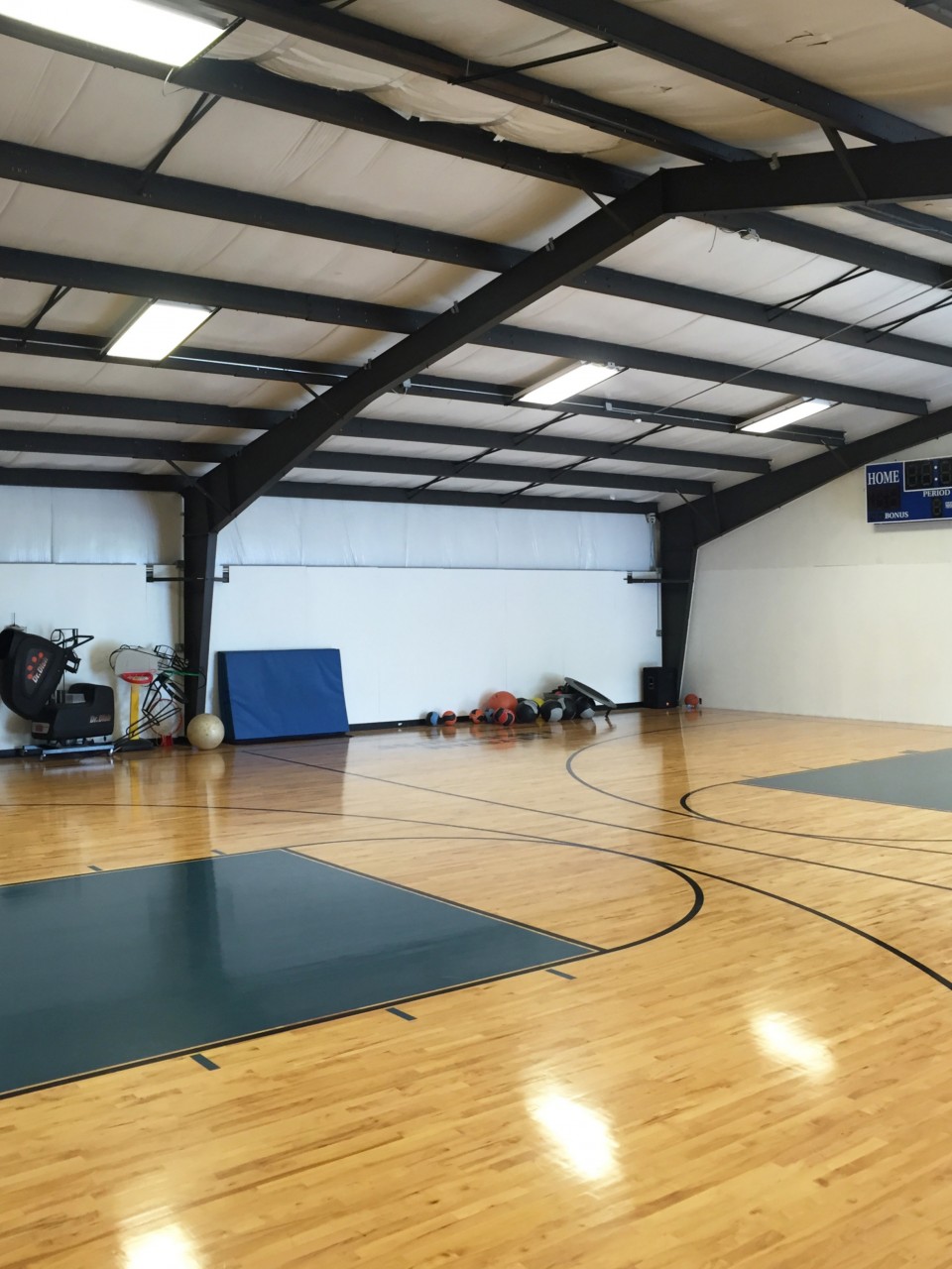 PE equipment stored alongside the wall in a gymnasium