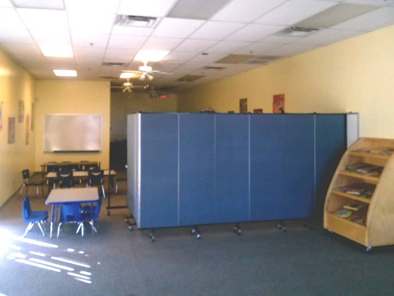 A nursing room is created with privacy screens in an empty room