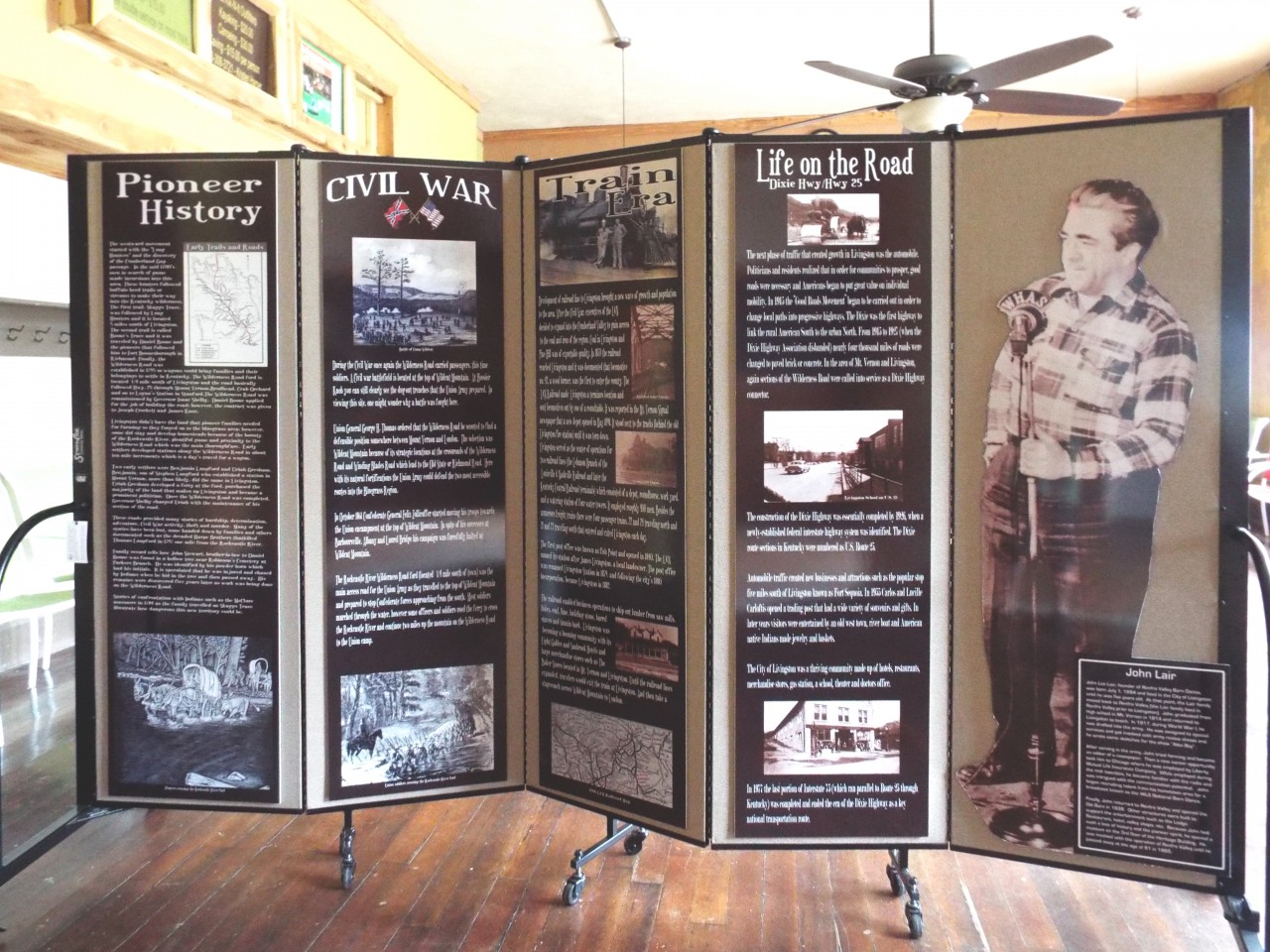 Historical museum display information hung on a 5 panel room divider