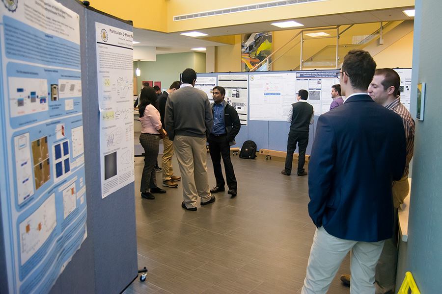 College hallway is lined with portable partitions for poster display