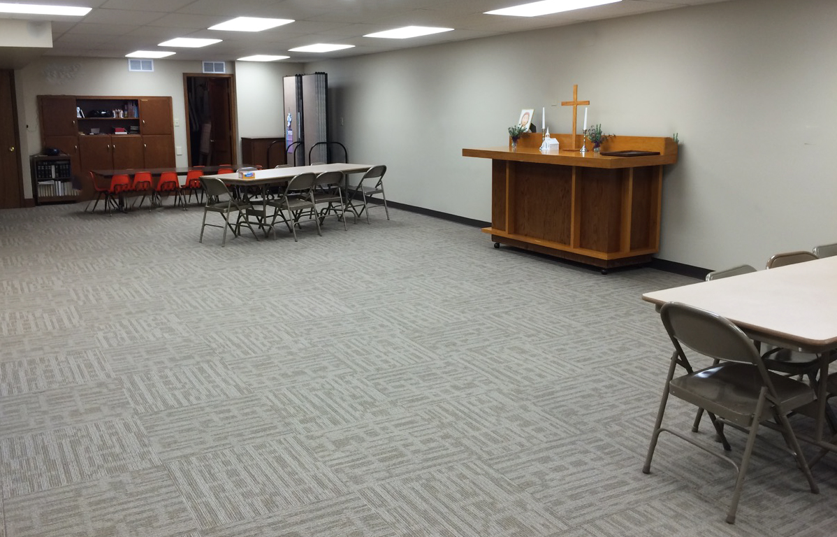 Room dividers are stored to the side waiting to be used in a church multipurpose room