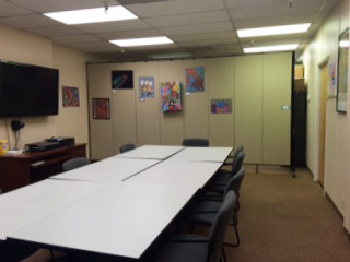 A conference room is split into two by a room divider