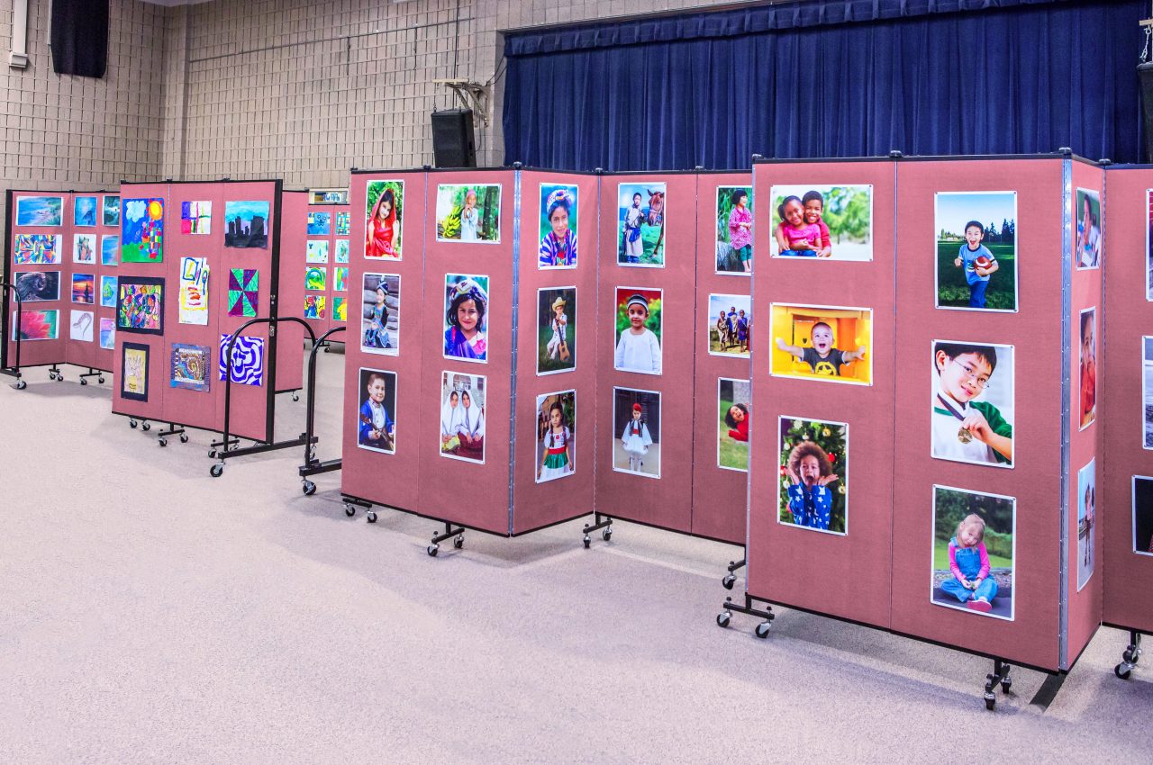 Create an artshow in a school gym with the help of tackable rolling dividers