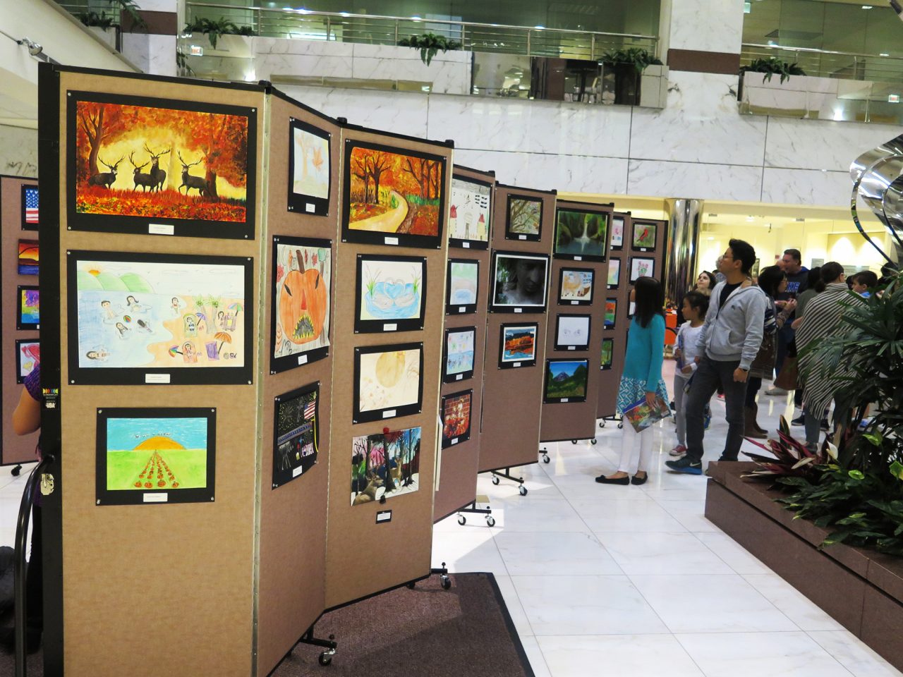 Movable art show display system allows a bank to showcase student artwork