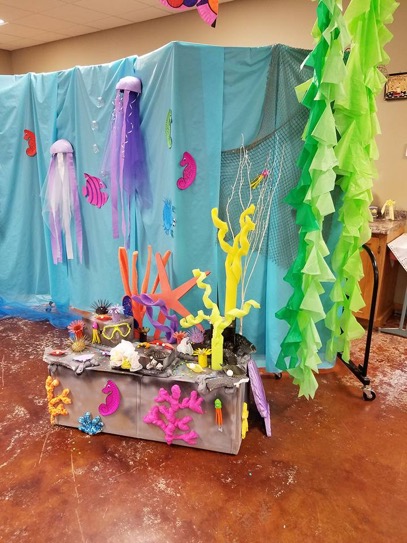 A sea theme VBS decorative backdrop is created on a rolling partition wall