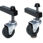 A set of self leveling caster wheels. One wheel is resting on a stack on quarters.