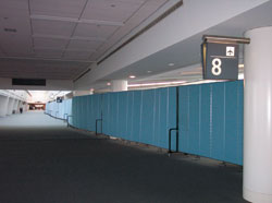 The Benefits of Using Rolling Temporary Walls For Aviation Facility Management & Security | Screenflex Portable Partitions Portable Screenflex Partitions dividing an Airport Terminal